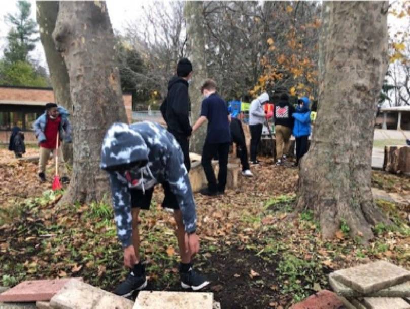 students installing birck and cement blocks Shawmut Hills sycamore circle mural site